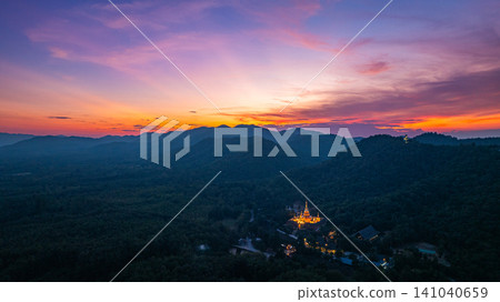 Aerial view of Majestic Buddha on the mountain at colorful sunset. Aerial view of Majestic Buddha on the mountain at colorful sunset. 141040659