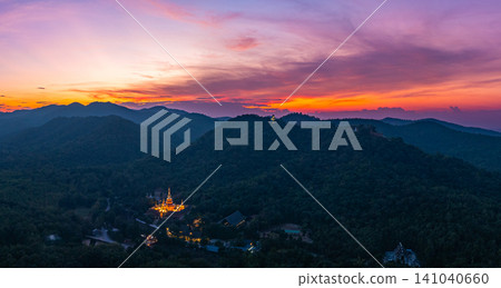 Aerial view of Majestic Buddha on the mountain at colorful sunset. Aerial view of Majestic Buddha on the mountain at colorful sunset. 141040660