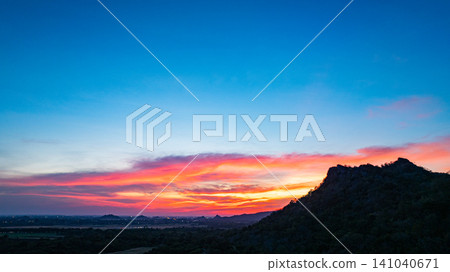 Aerial view Vibrant Sunset Over Mountain Peaks Aerial view Vibrant Sunset Over Mountain Peaks 141040671