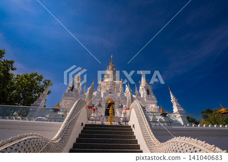 Ornate White Temple with Naga Guardians 141040683