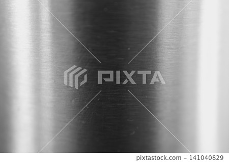 Silver metal surface showing brushed texture and bright reflections, representing strength, durability, and a modern industrial background design for products and websites 141040829
