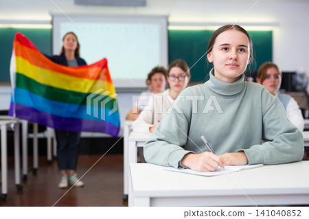 Teacher explaining meaning of LGBT flag to students Teacher explaining meaning of LGBT flag to students 141040852