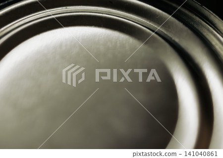 Silver metallic surface featuring a smooth texture and bright highlights, creating an abstract, industrial background with subtle circular grooves and shiny reflections Silver metallic surface featuring a smooth texture and bright highlights, creating an abstract, industrial background with subtle circular grooves and shiny reflections 141040861