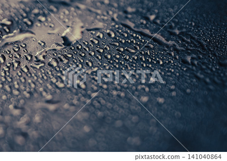 Water droplets on a dark metallic surface reflecting ligh and forming an abstract pattern in monochrome Water droplets on a dark metallic surface reflecting ligh and forming an abstract pattern in monochrome 141040864