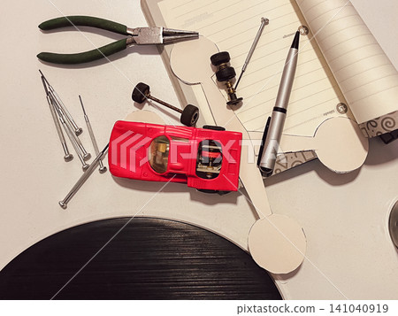 Top view of the tools and elements needed to repair or build a scale model car, combining skills and hands-on learning. Top view of the tools and elements needed to repair or build a scale model car, combining skills and hands-on learning. 141040919