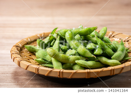 Freshly boiled edamame served in a colander Freshly boiled edamame served in a colander 141041164