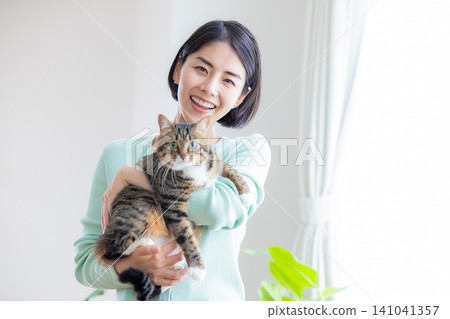 A woman holding her pet cat. A woman holding her pet cat. 141041357