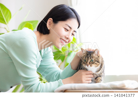 A woman holding her pet cat. A woman holding her pet cat. 141041377