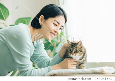 A woman holding her pet cat. A woman holding her pet cat. 141041379
