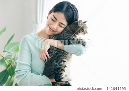 A woman holding her pet cat. A woman holding her pet cat. 141041393