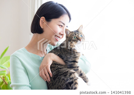 A woman holding her pet cat. A woman holding her pet cat. 141041398