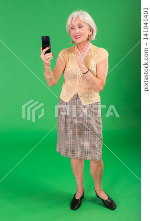 Senior woman in beige suit takes selfie Senior woman in beige suit takes selfie 141041401