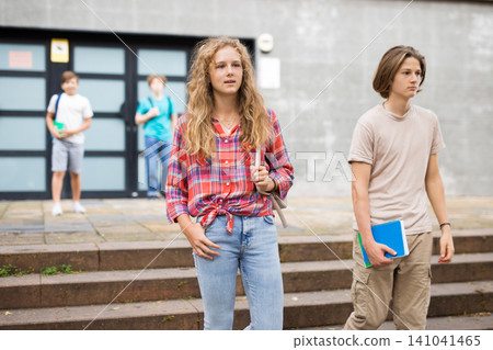 Portrait of teenage girl walking after lessons at sunny day 141041465