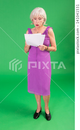 Upset and distressed senior woman person in pink dress with document, green screen Upset and distressed senior woman person in pink dress with document, green screen 141041531