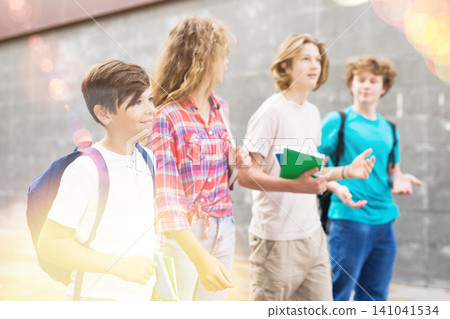 Students of middle school chatting and spending happy time together outside Students of middle school chatting and spending happy time together outside 141041534