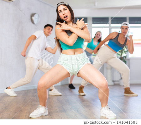 People learning swing steps at dance class and smiling People learning swing steps at dance class and smiling 141041593