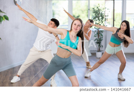 Group of girls and boys dancing and practicing new movements in class. Sport, dance and urban culture concept Group of girls and boys dancing and practicing new movements in class. Sport, dance and urban culture concept 141041667