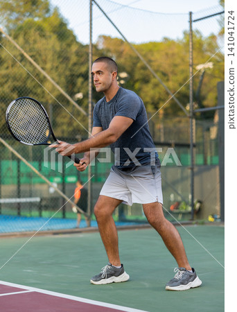 Man in sportswear playing tennis match Man in sportswear playing tennis match 141041724