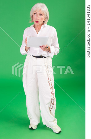 Upset and distressed senior woman person in white suit with document, green screen Upset and distressed senior woman person in white suit with document, green screen 141041835