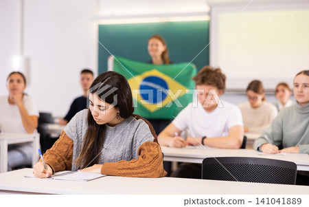 Young girl student diligently studies at school 141041889
