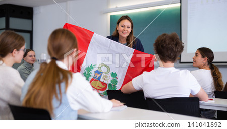 Female professor shows students flag of Peru 141041892