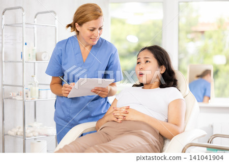 Asian woman signing a facial procedure contract Asian woman signing a facial procedure contract 141041904