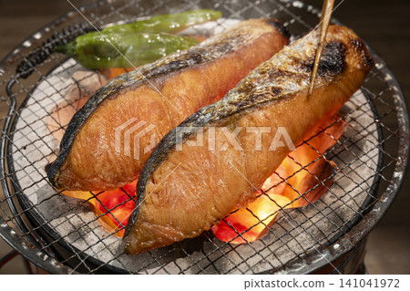 Grill salmon over charcoal. Grill salmon over charcoal. 141041972