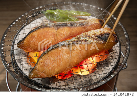 Grill salmon over charcoal. Grill salmon over charcoal. 141041978