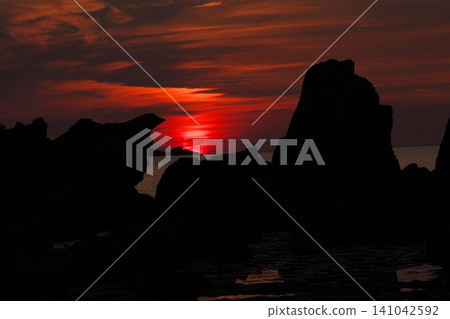 A rising sun on a bridge pile rock A rising sun on a bridge pile rock 141042592