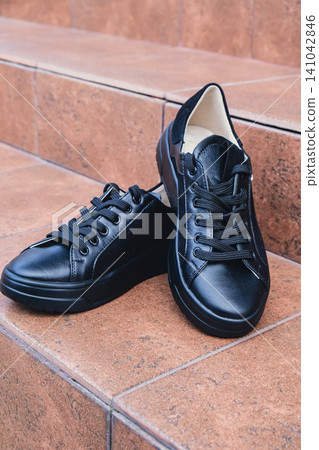 Elegant black leather womens shoes blank product for branding displayed. New casual female sneakers no-brand footwear e-commerce. No logo product Elegant black leather womens shoes blank product for branding displayed. New casual female sneakers no-brand footwear e-commerce. No logo product 141042846