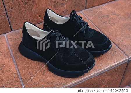 Elegant black leather womens shoes blank product for branding displayed. New casual female sneakers no-brand footwear e-commerce. No logo product Elegant black leather womens shoes blank product for branding displayed. New casual female sneakers no-brand footwear e-commerce. No logo product 141042850