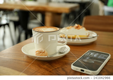 Coffee cup and dessert sit on a table in Bali Coffee cup and dessert sit on a table in Bali 141042966