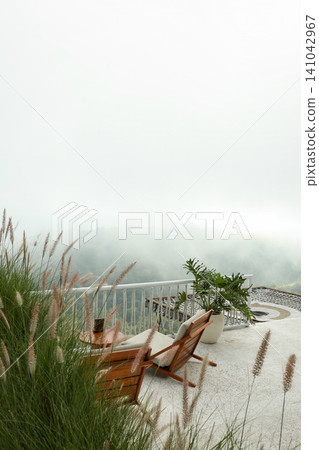 Seating area with chairs and plants in Bali with fog Seating area with chairs and plants in Bali with fog 141042967