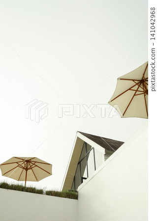 Umbrellas above a building in Bali with clear sky 141042968