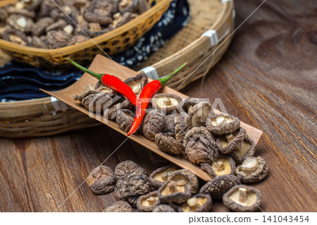 Dried Shiitake Mushrooms and Red Chili on Wooden Spoon Dried Shiitake Mushrooms and Red Chili on Wooden Spoon 141043454