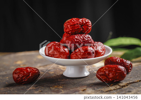 Dried Red Dates Jujube in White Bowl on Wooden Table Dried Red Dates Jujube in White Bowl on Wooden Table 141043456