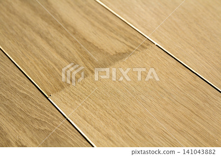 Natural light brown wooden parquet floor boards. Sunny soft yellow texture, copy space perspective background. Natural light brown wooden parquet floor boards. Sunny soft yellow texture, copy space perspective background. 141043882