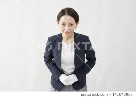 A female appraiser bows against a white background. A female appraiser bows against a white background. 141043965