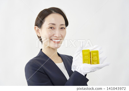 女性鑑定師手持金條，白色背景 141043972
