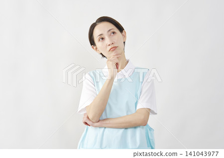 Female caregiver thinking, white background Female caregiver thinking, white background 141043977