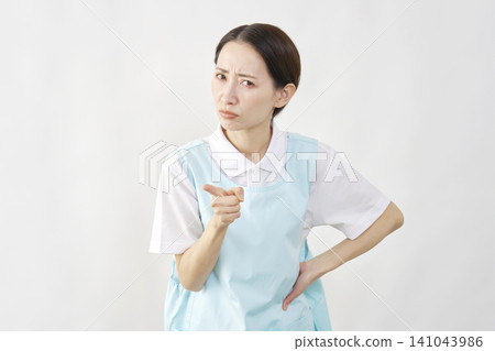 Female caregiver scolding a patient against a white background. 141043986