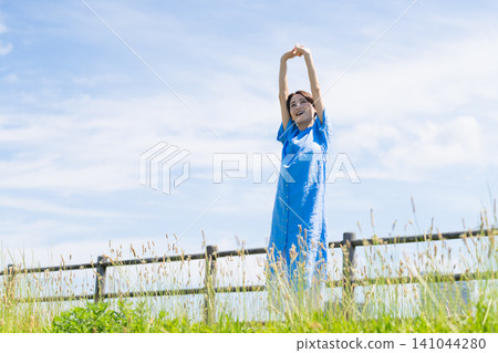 Young woman taking a deep breath lifestyle image Young woman taking a deep breath lifestyle image 141044280