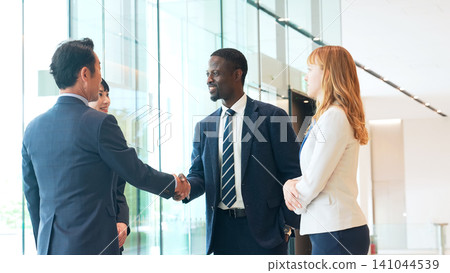 Group of multinational business people shaking hands in a lobby Group of multinational business people shaking hands in a lobby 141044539