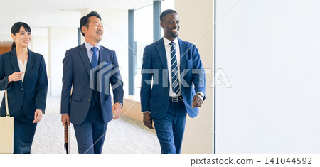 Group of multinational business people walking in a building Group of multinational business people walking in a building 141044592