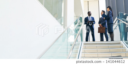 Group of multinational business people having a conversation in a lobby Group of multinational business people having a conversation in a lobby 141044612