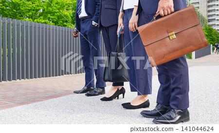 At the feet of a group of business people At the feet of a group of business people 141044624