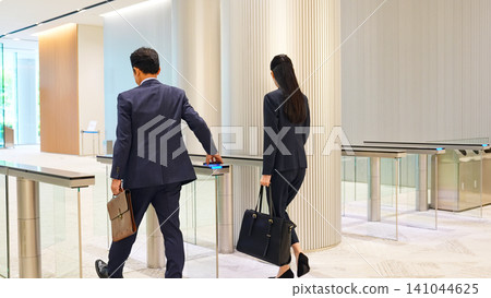 Group of multinational business people passing through a security gate Group of multinational business people passing through a security gate 141044625