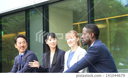 A group of multinational business people relaxing and talking A group of multinational business people relaxing and talking 141044679