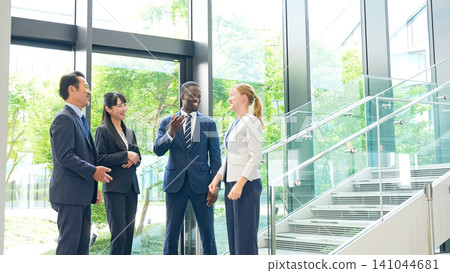Group of multinational business people talking in a lobby Group of multinational business people talking in a lobby 141044681