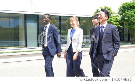 A group of multinational business people walking down an aisle A group of multinational business people walking down an aisle 141044685